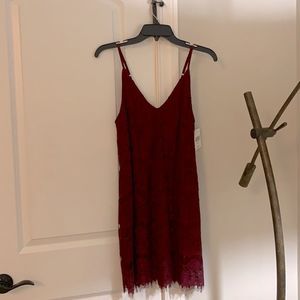 Fancy dress color red/berry w/ nice detailing. Size small, never worn with tags